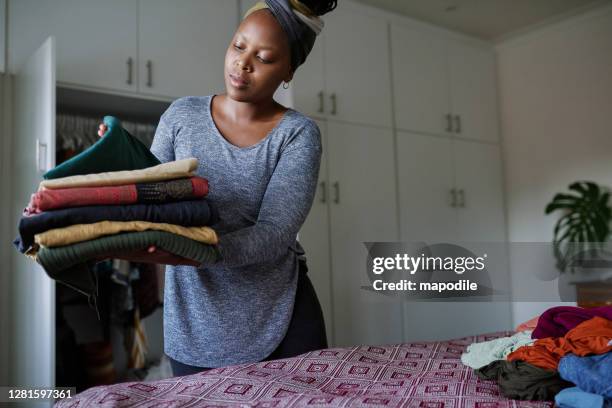 i keep every room organised - woman with folded clothes stock pictures, royalty-free photos & images