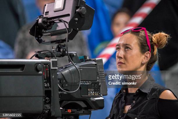 camerawoman operating camera in court - camera operator stock pictures, royalty-free photos & images