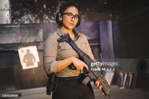 woman at shooting range - target shooting stock pictures, royalty-free photos & images
