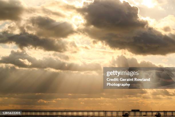 sunbeams over southend pier - southend stock pictures, royalty-free photos & images