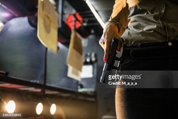 hand holding a gun - pistol stock pictures, royalty-free photos & images