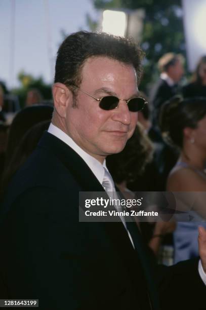 American actor and comedian Robert Wuhl wearing a black jacket over a white shirt, with a silver tie, and sunglasses, attends the 51st Annual...