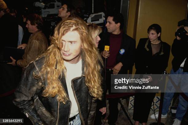 American singer and guitarist Dave Mustaine, of American heavy metal band Megadeth, wearing a black leather jacket over a white t-shirt, at an event...