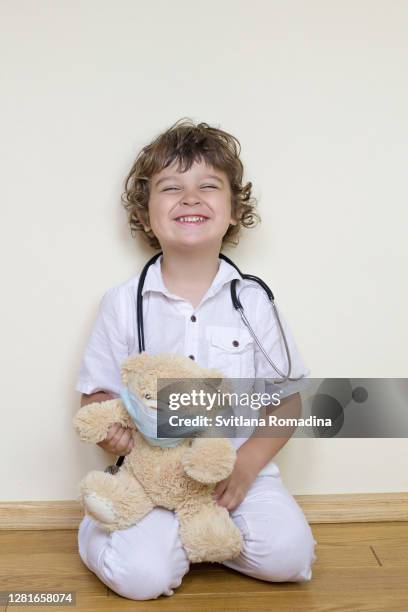 happy child with stethoscope playing doctor - children playing doctor photos et images de collection