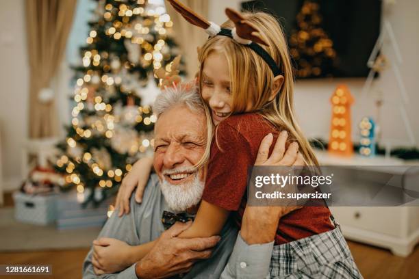 grandfather and granddaughter preparing for new year - xmas together stock pictures, royalty-free photos & images