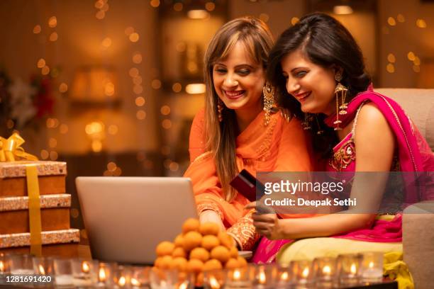 frau diwali feiert zu hause - stockfoto - diwali family stock-fotos und bilder