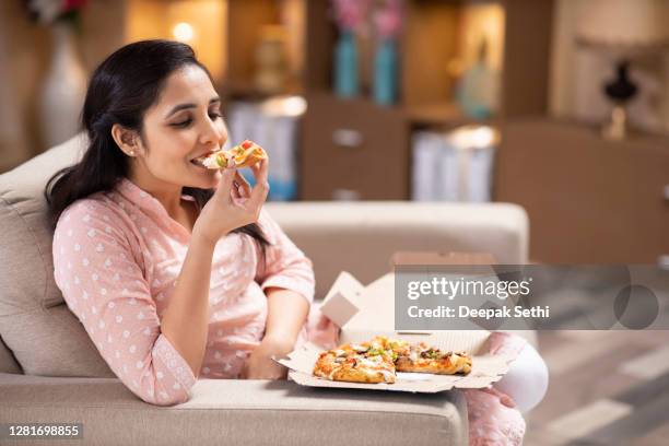 woman sofa sitting at home - stock photo - woman junk food eating stock pictures, royalty-free photos & images