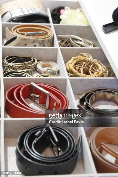 belts organized in drawer - ceinture par dessus photos et images de collection