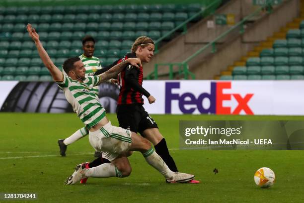 Jens Petter Hauge of AC Milan scores his sides third goal whilst under pressure from Shane Duffy of Celtic during the UEFA Europa League Group H...