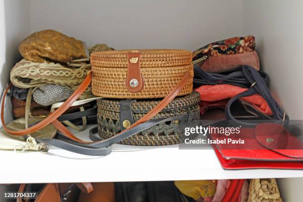 handbags in cupboard - wicker stockfoto's en -beelden