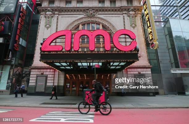 Person rides his bicycle past the closed AMC movie theaters in Times Square on October 22, 2020 in New York City.