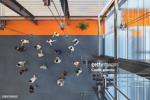 large group of business people in convention centre - elevated view stock pictures, royalty-free photos & images