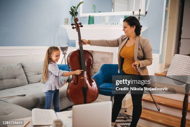 a music teacher and a student have fun - cello stock pictures, royalty-free photos & images