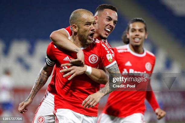 Andrés D'Alessandro of Internacional celebrates with teammate after scoring the first goal of his team during a Group E match of Copa CONMEBOL...