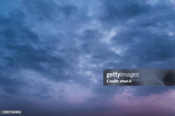 black clouds gather overhead - cloudy night sky stock pictures, royalty-free photos & images