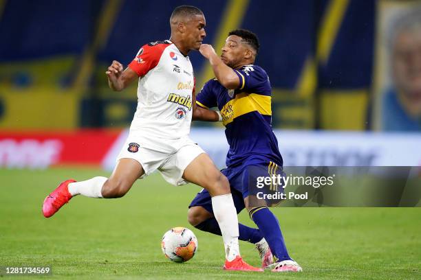 Frank Fabra of Boca Juniors clashes with Saul Guarirapa of Caracas during a Group H match of Copa CONMEBOL Libertadores 2020 between Boca Juniors and...