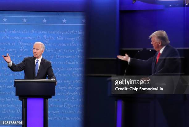 Democratic presidential nominee Joe Biden and U.S. President Donald Trump, shown in a reflection, participate in the final presidential debate at...