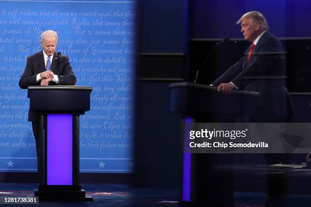 Democratic presidential nominee Joe Biden checks his watch during the final presidential debate against U.S. President Donald Trump at Belmont...