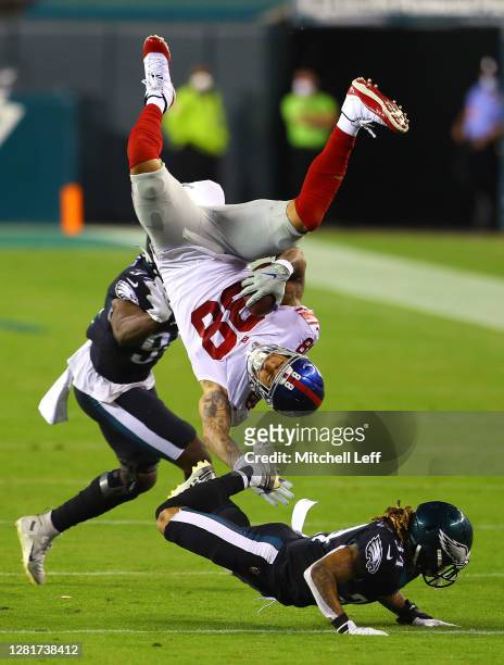 Evan Engram of the New York Giants flips over Cre'von LeBlanc of the Philadelphia Eagles as Josh Sweat during the third quarter defends at Lincoln...