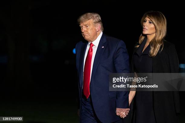 President Donald Trump and first lady Melania Trump walk on the south lawn of the White House on October 23, 2020 in Washington, DC. The Trumps were...
