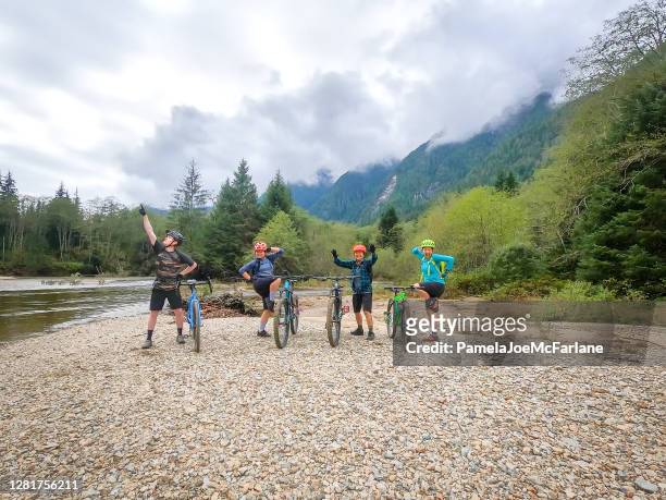 mountain biking, family and friends posing with balancing bikes - canadian wilderness stock pictures, royalty-free photos & images