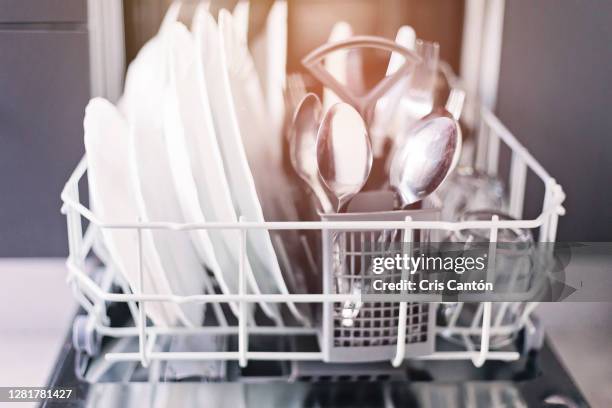 open dishwasher with clean dishes and cutlery - dishwasher stock-fotos und bilder