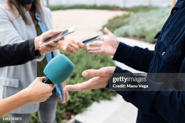 close-up of an interview with smartphones and microphone - stock photo - television journalists fotografías e imágenes de stock