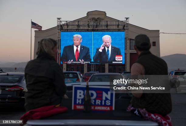 People watch the final U.S. Presidential debate between President Donald Trump and Democratic candidate Joe Biden outside Cowell Theater on October...