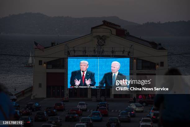 People watch the final U.S. Presidential debate between President Donald Trump and Democratic candidate Joe Biden outside Cowell Theater on October...