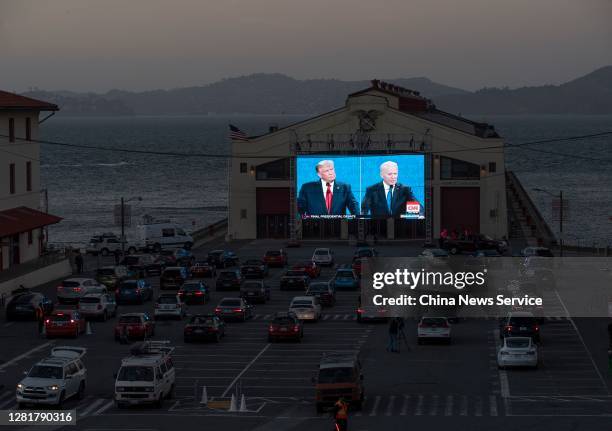 People watch the final U.S. Presidential debate between President Donald Trump and Democratic candidate Joe Biden outside Cowell Theater on October...