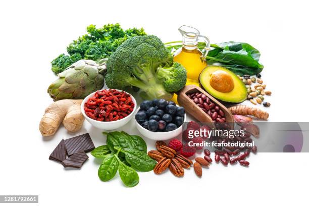 group of vegan food rich in antioxidants on white background - avacado oil stock pictures, royalty-free photos & images