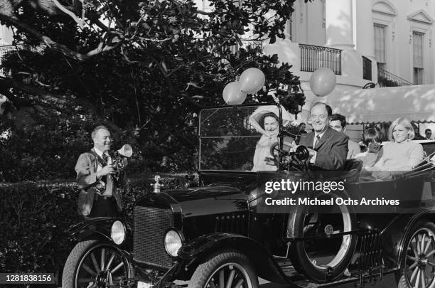 Vice President Hubert Humphrey drives the First Lady, Lady Bird Johnson in a vintage Ford car at President Lyndon B Johnson's Country Fair on the...