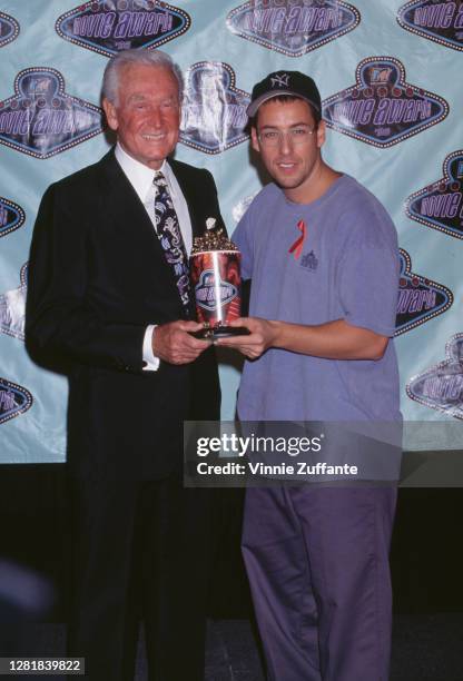 American television host Bob Barker and American actor Adam Sandler at the 1996 MTV Movie Awards with their award for 'Best Fight' at Walt Disney...