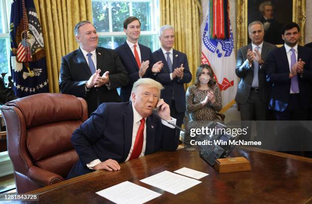 President Donald Trump speaks with Israeli Prime Minister Benjamin Netanyau on the phone about a Sudan-Israel peace agreement, in the Oval Office on...