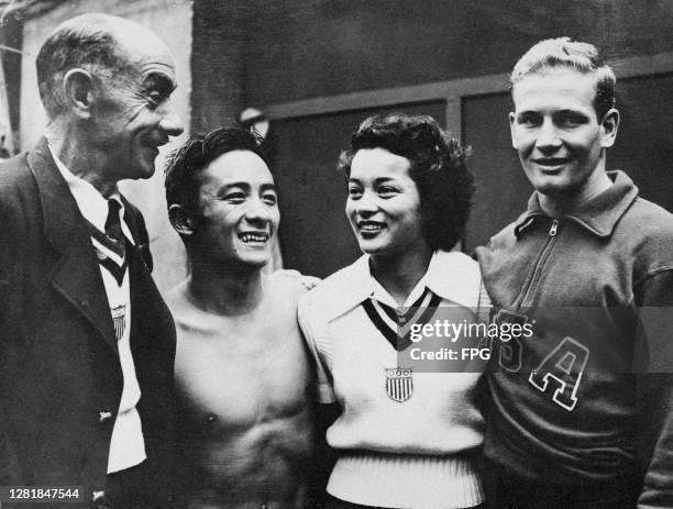 Three medallists from the US Olympic diving team with their coach Fred Cady at the Empire Pool in Wembley, during the 1948 Summer Olympics in London,...