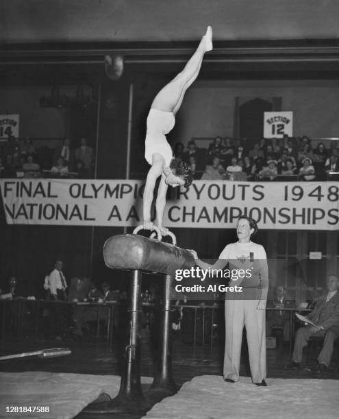 American gymnast Clara Schroth performs a side horse vault during try-outs for the US Olympic team in Philadelphia, USA, 8th May 1948. She won a...