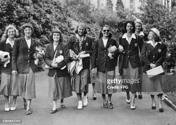Female members of the US Olympic swimming and diving team head to the Epsom baths to train for the 1948 Summer Olympics in London, UK, 1948. They...