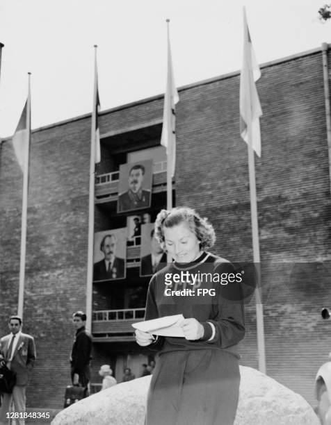 Soviet discus thrower Nina Romashkova reading a letter from home at the Soviet camp in Otaniemi, during the Summer Olympic Games in Helsinki,...