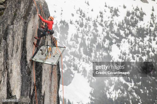 rock climber uses prusik to ascend cliff above portaledge. - ascender stock pictures, royalty-free photos & images