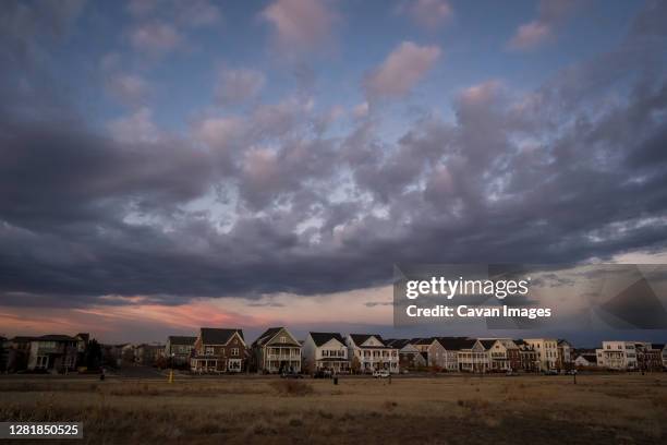 the view of sunset over neighborhood houses from an adjacent park - denver winter stock pictures, royalty-free photos & images