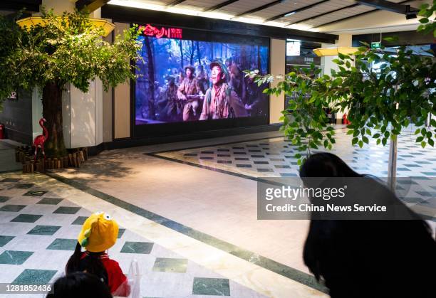 People watch a trailer for the movie 'The Sacrifice' at a cinema on October 23, 2020 in Beijing, China.