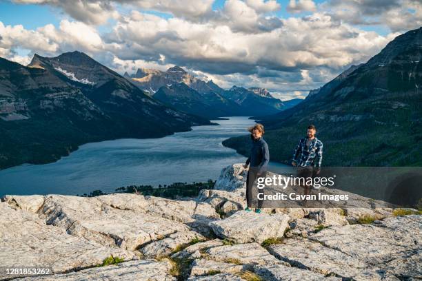 couple hiking on bear's hump mountain in waterton lakes national park - waterton lakes national park stock pictures, royalty-free photos & images