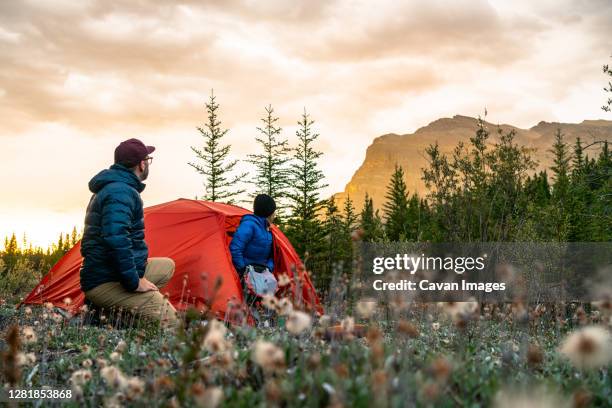 couple enjoying sunrise from camping spot along david thompson highway - サスカチュワン州 ストックフォトと画像