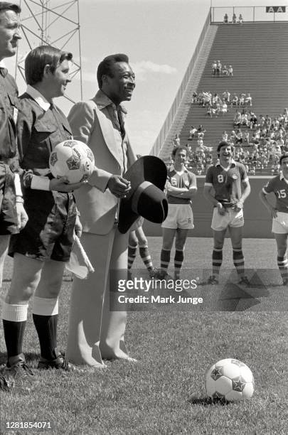 Former standout player Pele holds his gifted cowboy hat while being celebrated during a soccer game between the Colorado Caribous and the New York...