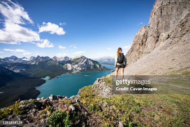 hiker overlooking upper kananaskis lake during sunset in summer - kananaskis stock pictures, royalty-free photos & images