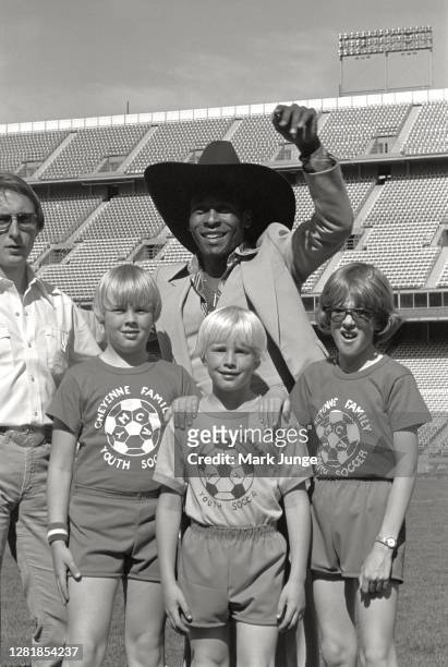Former standout player Pele poses with three young soccer players Andy Junge, Dan Junge and Jeff Nesheim from Cheyenne, Wyoming during a soccer game...