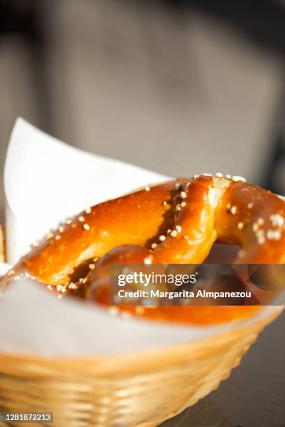 salted butter pretzel in a baskey - baskey stock pictures, royalty-free photos & images