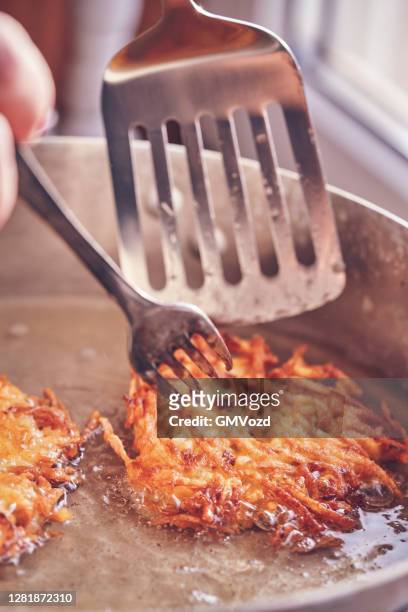 preparing rosti potato pancake in domestic kitchen - potato pancake stock pictures, royalty-free photos & images