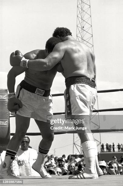 Lyle Alzado , goes into a clinch against Muhammad Ali during an eight-round exhibition match at Mile High Stadium on July 14, 1979 in Denver,...