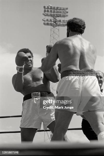 Muhammad Ali , blocks a punch from Lyle Alzado during an eight-round exhibition match at Mile High Stadium on July 14, 1979 in Denver, Colorado. Ali...